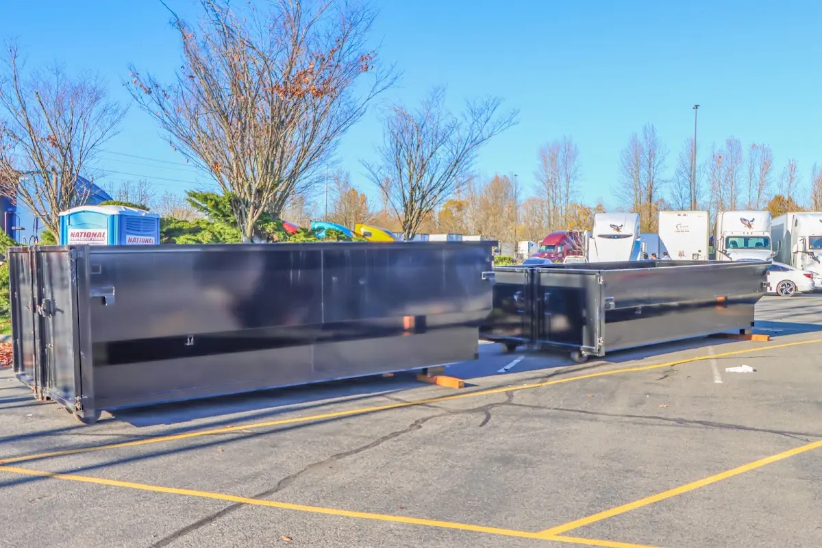 Professional dumpster rental service with roll-off container on residential driveway in Merchantville